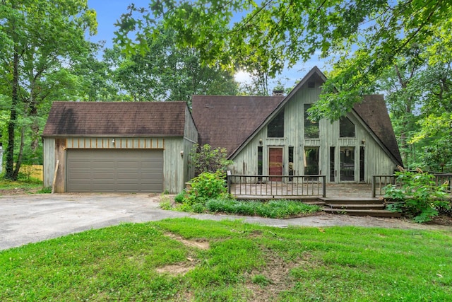 1811 Angel Ln, Signal Mountain, TN 37377 - a-frame style home with concrete driveway, an attached garage, a shingled roof, a wooden deck, and a front lawn