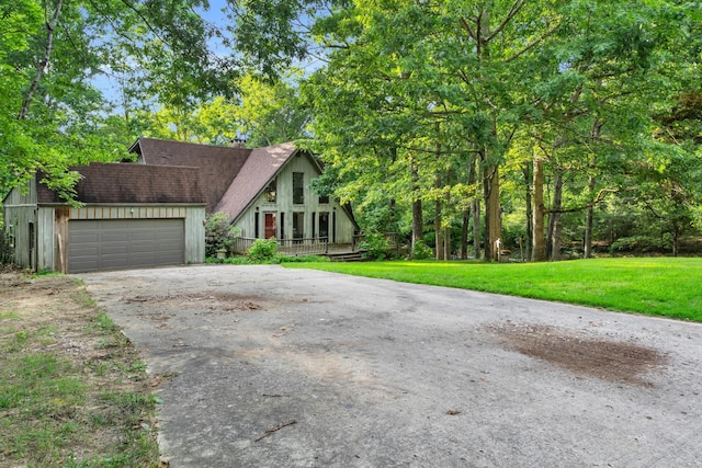 1811 Angel Ln, Signal Mountain, TN 37377 - a-frame home with concrete driveway, a garage, a front lawn, and roof with shingles
