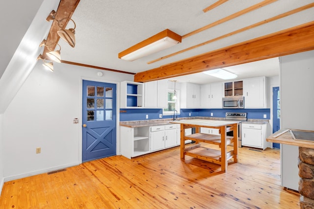 1811 Angel Ln, Signal Mountain, TN 37377 - kitchen with open shelves, appliances with stainless steel finishes, white cabinets, and light wood-type flooring