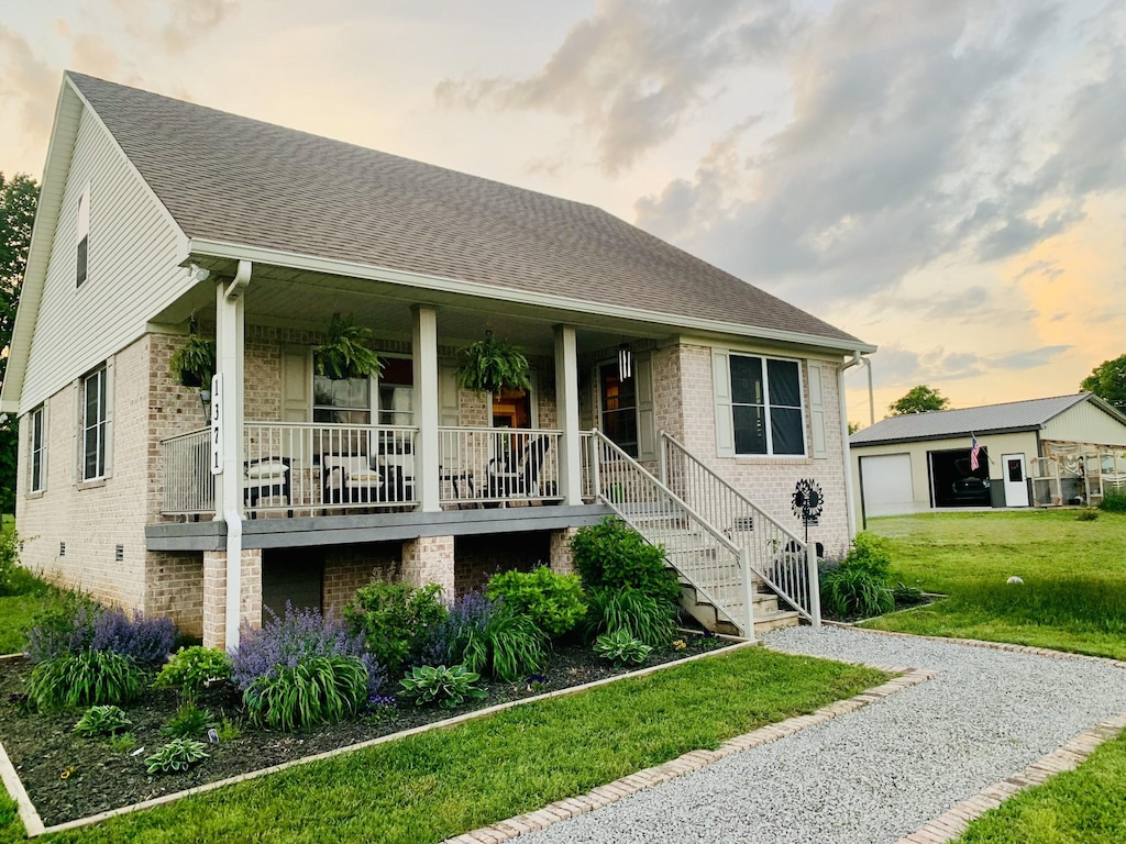 1371 Verona Caney Rd, Lewisburg, TN 37091 - view of front of home featuring a porch, brick siding, a front lawn, a shingled roof, and stairs