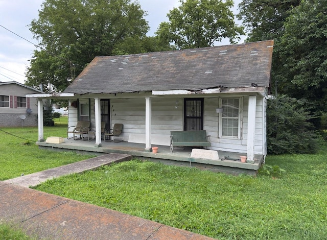 209 Olive St, Mount Pleasant, TN 38474 - bungalow with a porch, a front lawn, and a shingled roof