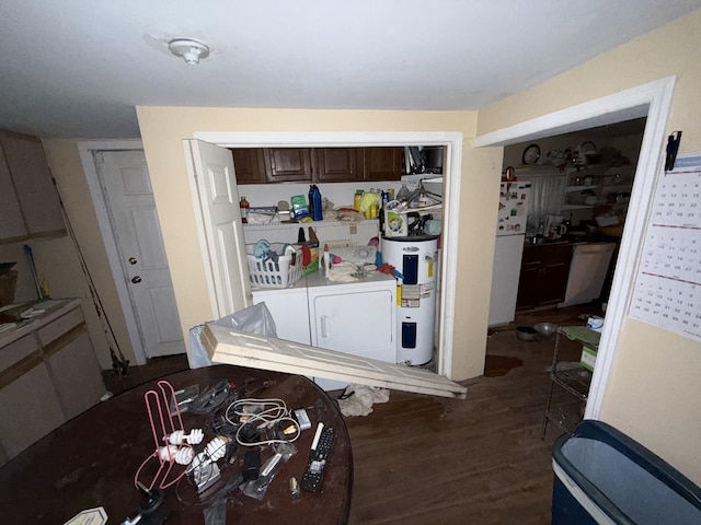 209 Olive St, Mount Pleasant, TN 38474 - kitchen featuring washing machine and clothes dryer, dark wood-style floors, electric water heater, dark brown cabinets, and light countertops