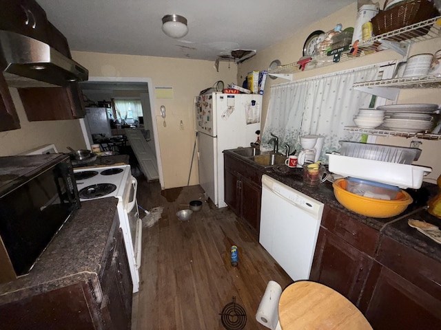 209 Olive St, Mount Pleasant, TN 38474 - kitchen with white appliances, dark countertops, under cabinet range hood, dark wood finished floors, and dark brown cabinets