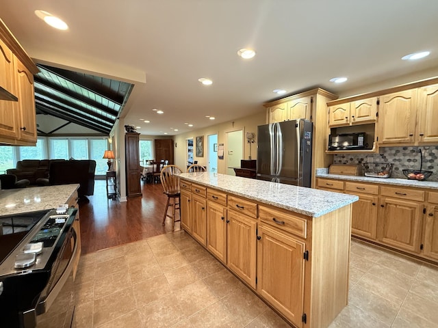 2680 Cedar Grove Rd, Lebanon, TN 37087 - kitchen with appliances with stainless steel finishes, a center island, light stone counters, backsplash, and recessed lighting