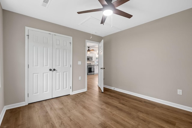 1615 Mohawk Trl, Hopkinsville, KY 42240 - unfurnished bedroom with attic access, wood finished floors, a closet, and ceiling fan