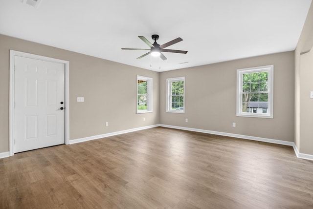 1615 Mohawk Trl, Hopkinsville, KY 42240 - empty room with plenty of natural light, ceiling fan, and wood finished floors