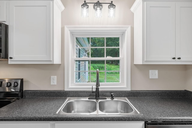 1615 Mohawk Trl, Hopkinsville, KY 42240 - kitchen featuring dark countertops, stainless steel electric range, white cabinetry, and dishwashing machine