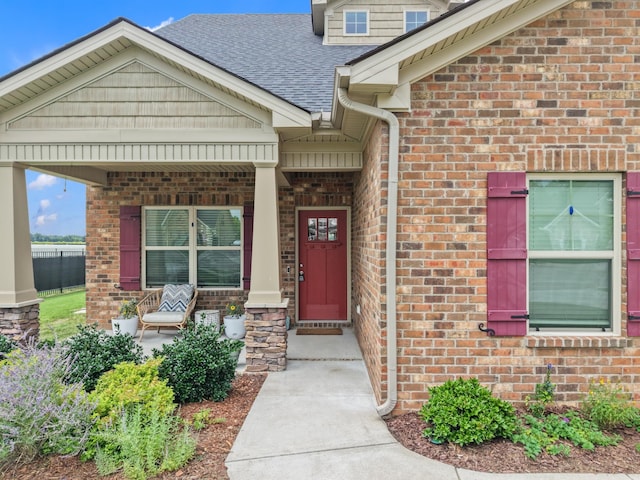 611 Hawkeye Ct, Eagleville, TN 37060 - doorway to property with a porch, a shingled roof, and brick siding