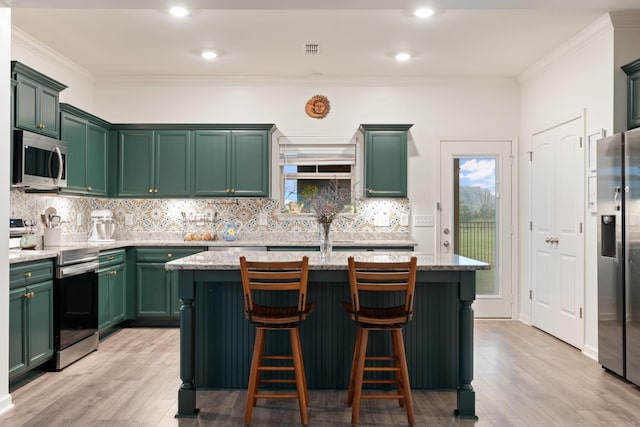 611 Hawkeye Ct, Eagleville, TN 37060 - kitchen with appliances with stainless steel finishes, green cabinetry, light wood-type flooring, healthy amount of natural light, and ornamental molding