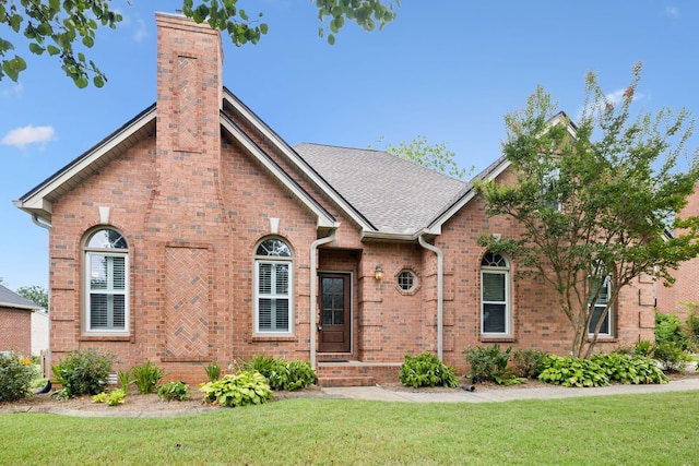 2707 Albany Ct, Murfreesboro, TN 37129 - tudor house featuring brick siding, a chimney, and a front lawn