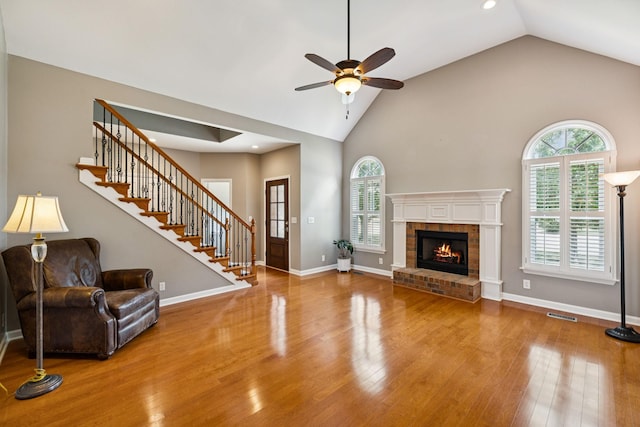 2707 Albany Ct, Murfreesboro, TN 37129 - unfurnished living room featuring a ceiling fan, plenty of natural light, wood finished floors, a fireplace, and high vaulted ceiling