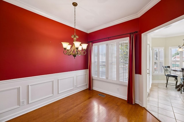2707 Albany Ct, Murfreesboro, TN 37129 - unfurnished dining area with a chandelier, ornamental molding, wainscoting, and wood finished floors