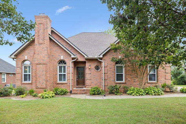 2707 Albany Ct, Murfreesboro, TN 37129 - view of front of home with brick siding, a front lawn, a chimney, and roof with shingles