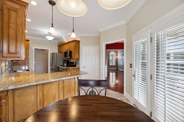2707 Albany Ct, Murfreesboro, TN 37129 - kitchen with stainless steel appliances, crown molding, tile patterned flooring, brown cabinetry, and a peninsula