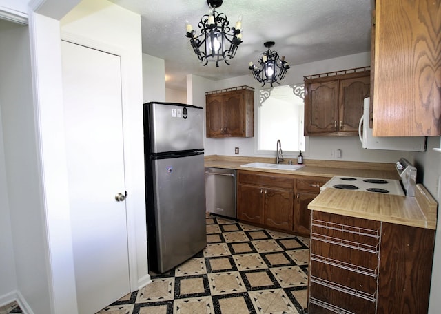 2117 Mockingbird Ln Unit A, Springfield, TN 37172 - kitchen featuring stainless steel appliances, light countertops, light flooring, a chandelier, and decorative light fixtures