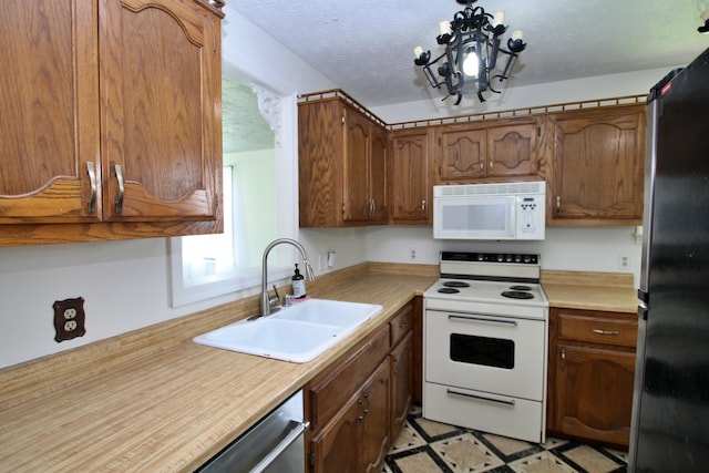2117 Mockingbird Ln Unit A, Springfield, TN 37172 - kitchen featuring stainless steel appliances, light countertops, brown cabinets, and a textured ceiling