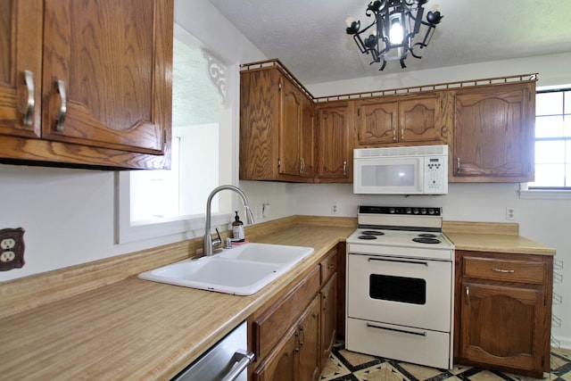 2117 Mockingbird Ln Unit A, Springfield, TN 37172 - kitchen featuring white appliances, light countertops, brown cabinetry, and a chandelier
