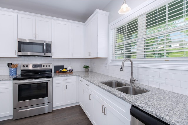 118 Colson Rd, Dover, TN 37058 - kitchen featuring stainless steel appliances, white cabinetry, tasteful backsplash, dark wood-type flooring, and light stone counters