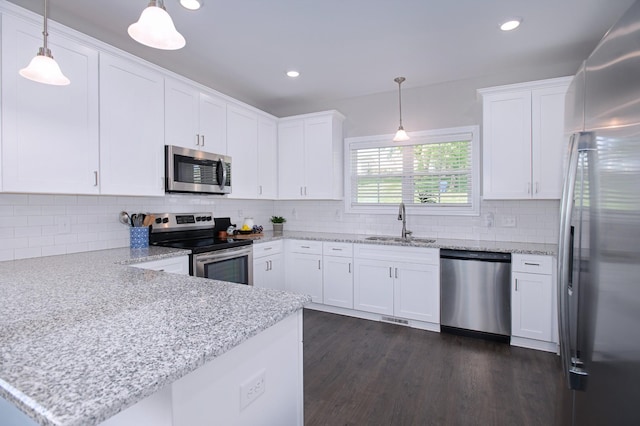 118 Colson Rd, Dover, TN 37058 - kitchen with stainless steel appliances, a peninsula, white cabinetry, dark wood-style flooring, and recessed lighting