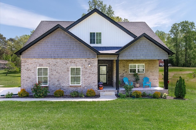 118 Colson Rd, Dover, TN 37058 - view of front facade with a porch, a front yard, brick siding, and a shingled roof