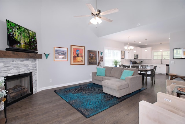 118 Colson Rd, Dover, TN 37058 - living area with dark wood finished floors, a chandelier, ceiling fan, a stone fireplace, and a towering ceiling