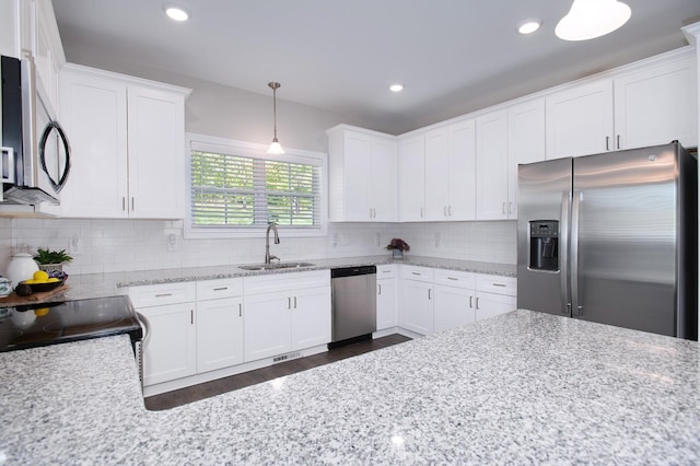 118 Colson Rd, Dover, TN 37058 - kitchen with stainless steel appliances, white cabinets, dark wood-style flooring, decorative light fixtures, and backsplash