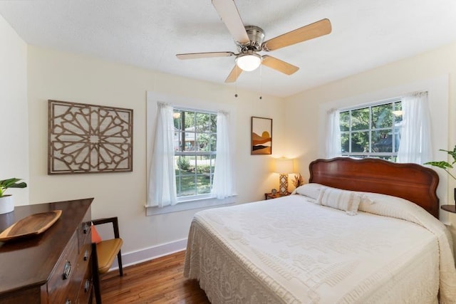 3102 Crescent Cir, Chattanooga, TN 37407 - bedroom with wood finished floors, multiple windows, and a ceiling fan