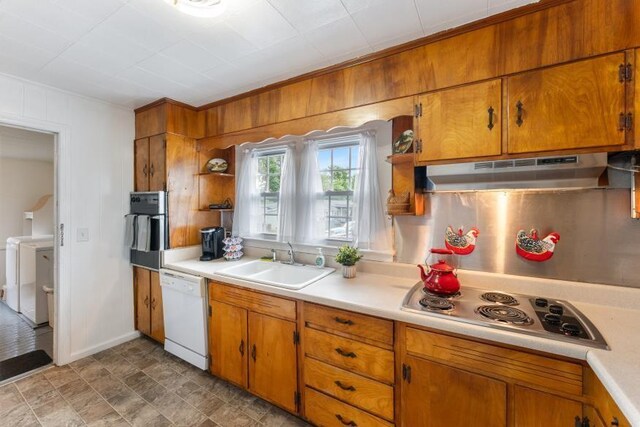 3102 Crescent Cir, Chattanooga, TN 37407 - kitchen featuring white dishwasher, under cabinet range hood, washer and clothes dryer, light countertops, and wood walls