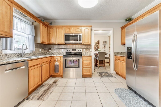 615 S Moore Rd, Chattanooga, TN 37412 - kitchen featuring stainless steel appliances, backsplash, ornamental molding, light stone countertops, and light tile patterned flooring