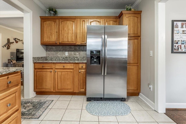 615 S Moore Rd, Chattanooga, TN 37412 - kitchen with stainless steel fridge with ice dispenser, crown molding, brown cabinetry, and light tile patterned flooring