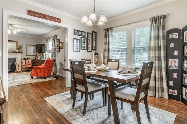 615 S Moore Rd, Chattanooga, TN 37412 - dining space featuring wood finished floors, crown molding, a fireplace, a chandelier, and ceiling fan