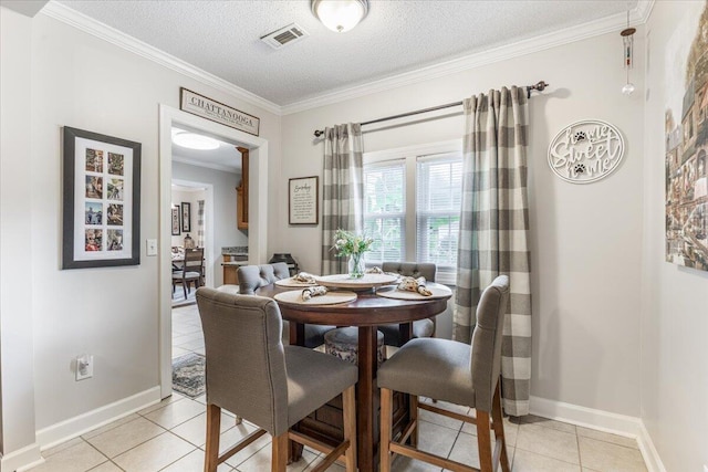 615 S Moore Rd, Chattanooga, TN 37412 - dining room with light tile patterned floors, crown molding, and a textured ceiling