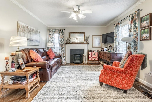 615 S Moore Rd, Chattanooga, TN 37412 - living area featuring wood finished floors, ornamental molding, a wood stove, a ceiling fan, and a textured ceiling
