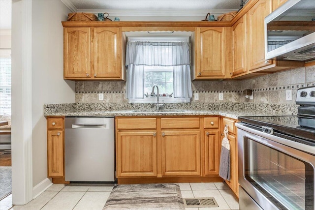 615 S Moore Rd, Chattanooga, TN 37412 - kitchen with appliances with stainless steel finishes, light tile patterned floors, light stone counters, crown molding, and tasteful backsplash