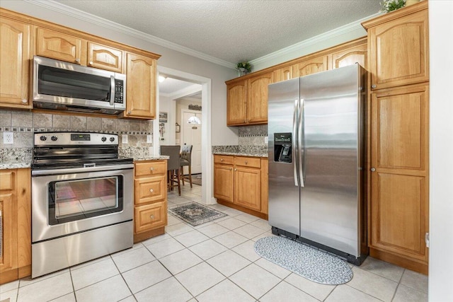 615 S Moore Rd, Chattanooga, TN 37412 - kitchen featuring stainless steel appliances, light tile patterned floors, decorative backsplash, ornamental molding, and light stone counters