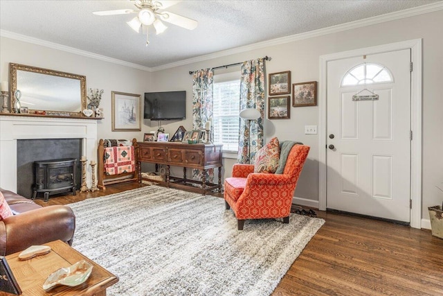 615 S Moore Rd, Chattanooga, TN 37412 - living area with a wood stove, wood finished floors, ceiling fan, ornamental molding, and a textured ceiling