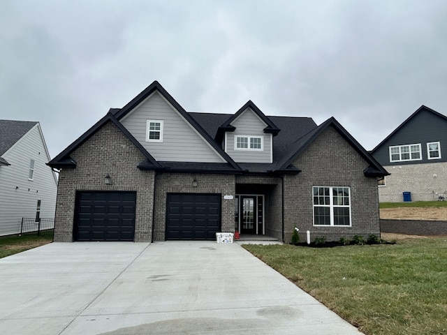 2005 S Byrnes St, Smyrna, TN 37167 - view of front of house with driveway, brick siding, a front lawn, and a garage