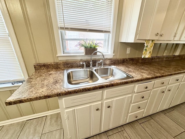 3084 Edgeware Rd S, Memphis, TN 38118 - kitchen with white cabinets, light wood-style flooring, and dark countertops