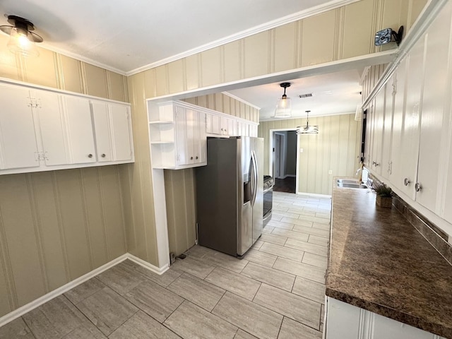 3084 Edgeware Rd S, Memphis, TN 38118 - kitchen featuring appliances with stainless steel finishes, white cabinets, ornamental molding, dark countertops, and open shelves