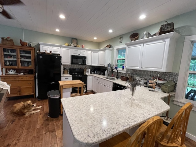 407 Cedar Rd, Pikeville, TN 37367 - kitchen featuring black appliances, a peninsula, plenty of natural light, a breakfast bar, and recessed lighting
