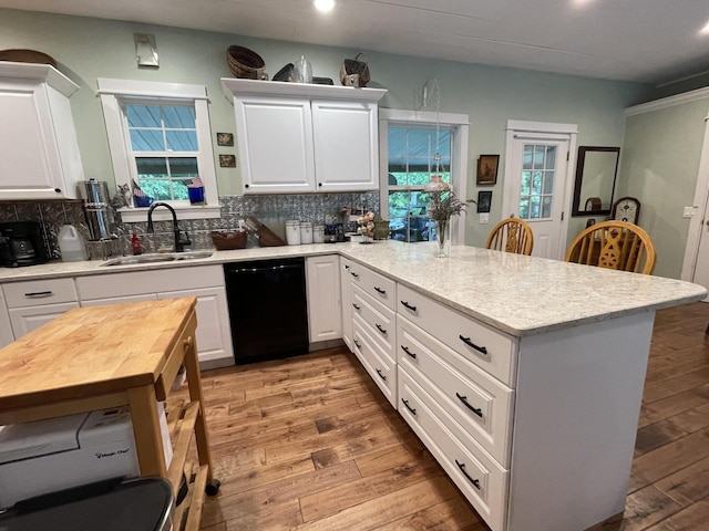 407 Cedar Rd, Pikeville, TN 37367 - kitchen featuring dishwasher, a peninsula, light wood-style flooring, decorative backsplash, and white cabinetry