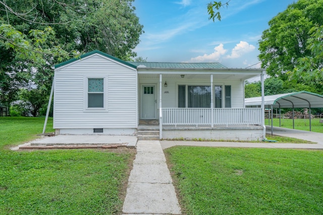 400 7th Ave, Fayetteville, TN 37334 - view of front facade featuring a porch, crawl space, a front lawn, a detached carport, and a metal roof