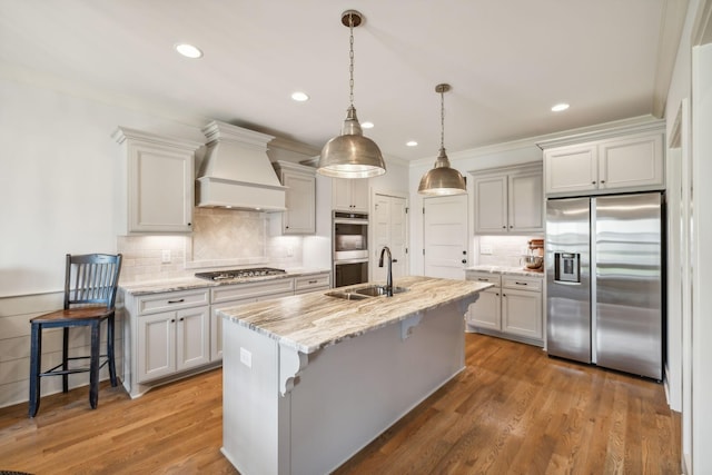 1111 Willow Springs Dr, Lebanon, TN 37087 - kitchen featuring appliances with stainless steel finishes, custom exhaust hood, decorative backsplash, a kitchen breakfast bar, and light stone countertops