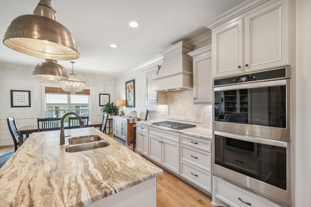 1111 Willow Springs Dr, Lebanon, TN 37087 - kitchen featuring stainless steel appliances, custom exhaust hood, light wood finished floors, light stone counters, and recessed lighting