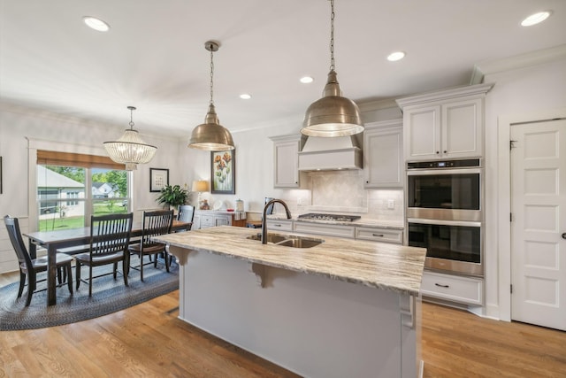1111 Willow Springs Dr, Lebanon, TN 37087 - kitchen featuring stainless steel appliances, light stone countertops, backsplash, wood finished floors, and recessed lighting
