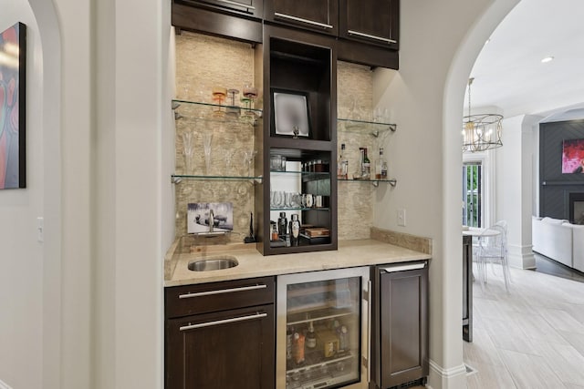 3 Annandale, Nashville, TN 37215 - indoor wet bar featuring beverage cooler, arched walkways, a chandelier, and refrigerator