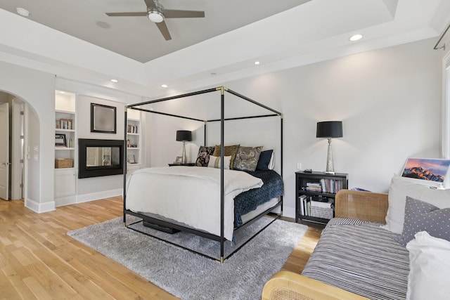 3 Annandale, Nashville, TN 37215 - bedroom with arched walkways, a tray ceiling, light wood-style floors, and recessed lighting
