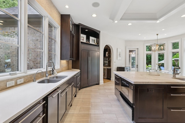 3 Annandale, Nashville, TN 37215 - kitchen with arched walkways, recessed lighting, paneled fridge, dark brown cabinetry, and pendant lighting