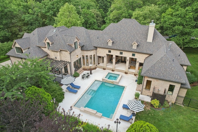 3 Annandale, Nashville, TN 37215 - rear view of property with a chimney, a fenced backyard, a view of trees, a patio area, and a pool with connected hot tub