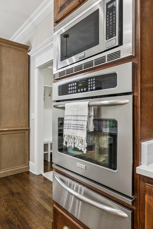 1808 Mosaic Trl, Murfreesboro, TN 37130 - kitchen view of a warming drawer, appliances with stainless steel finishes, ornamental molding, and dark wood-type flooring